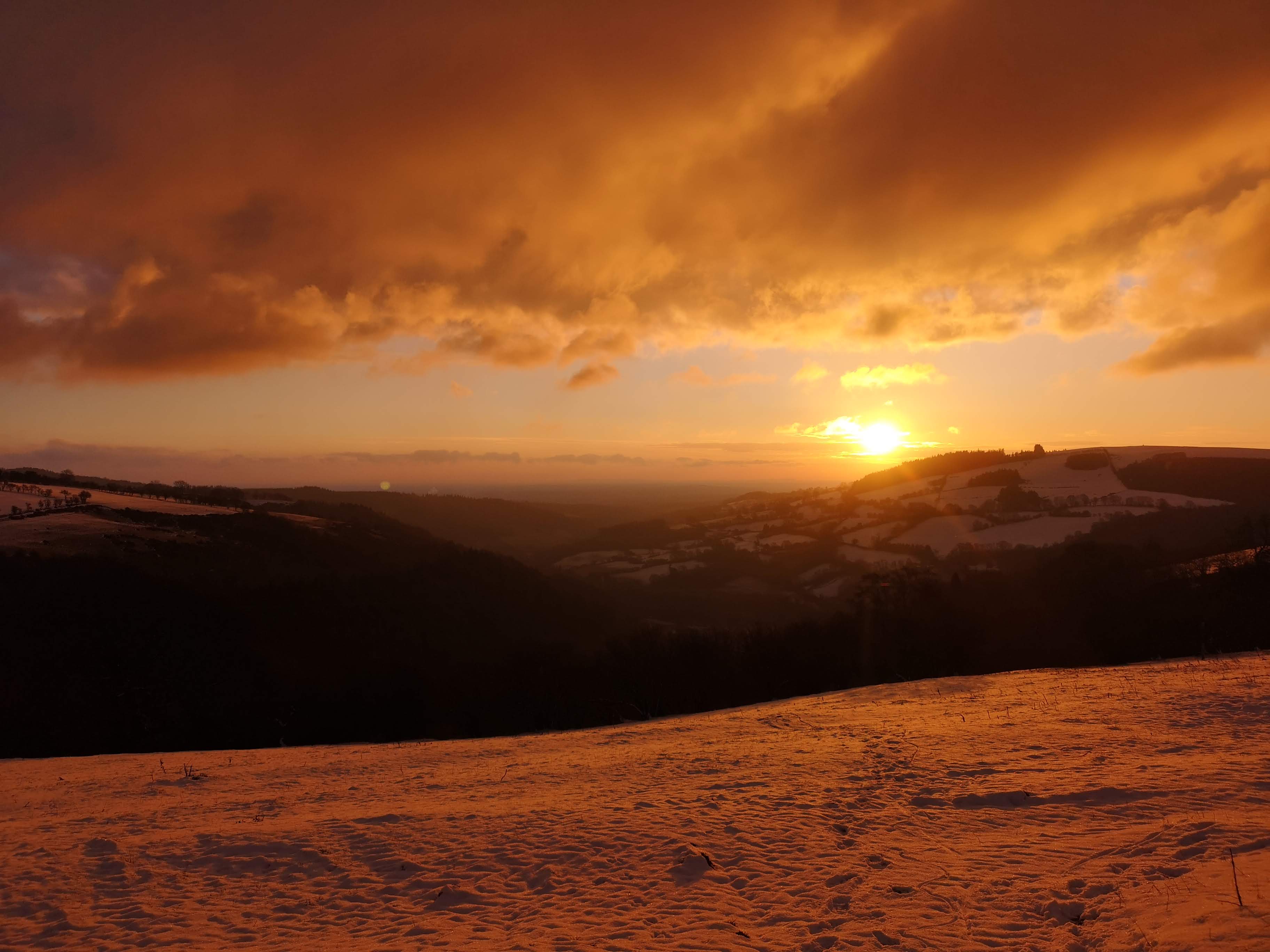 Spectacular golden sunset over Scottish Highland hills and valleys