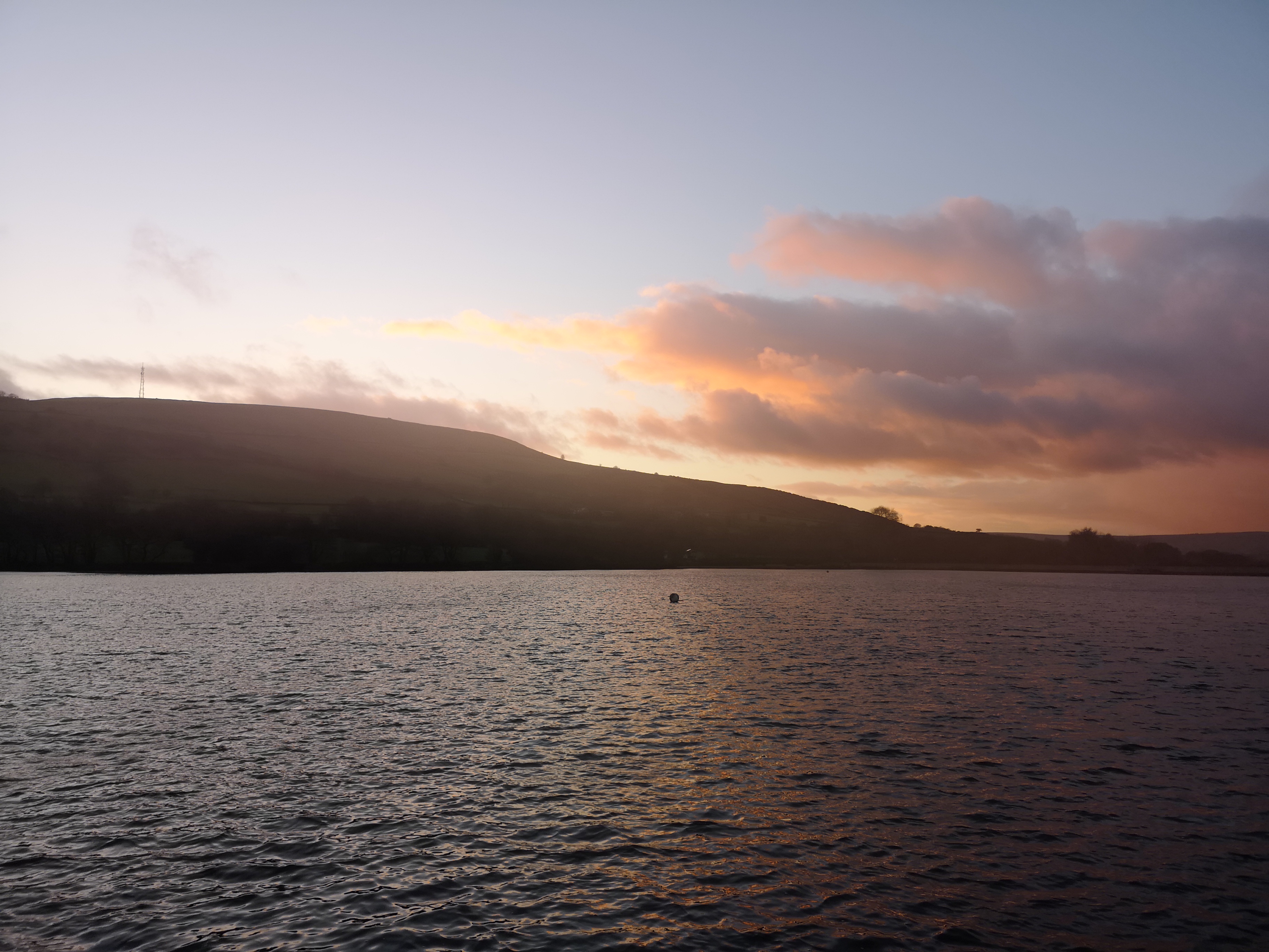 Scottish loch at sunset with vibrant orange and pink sky