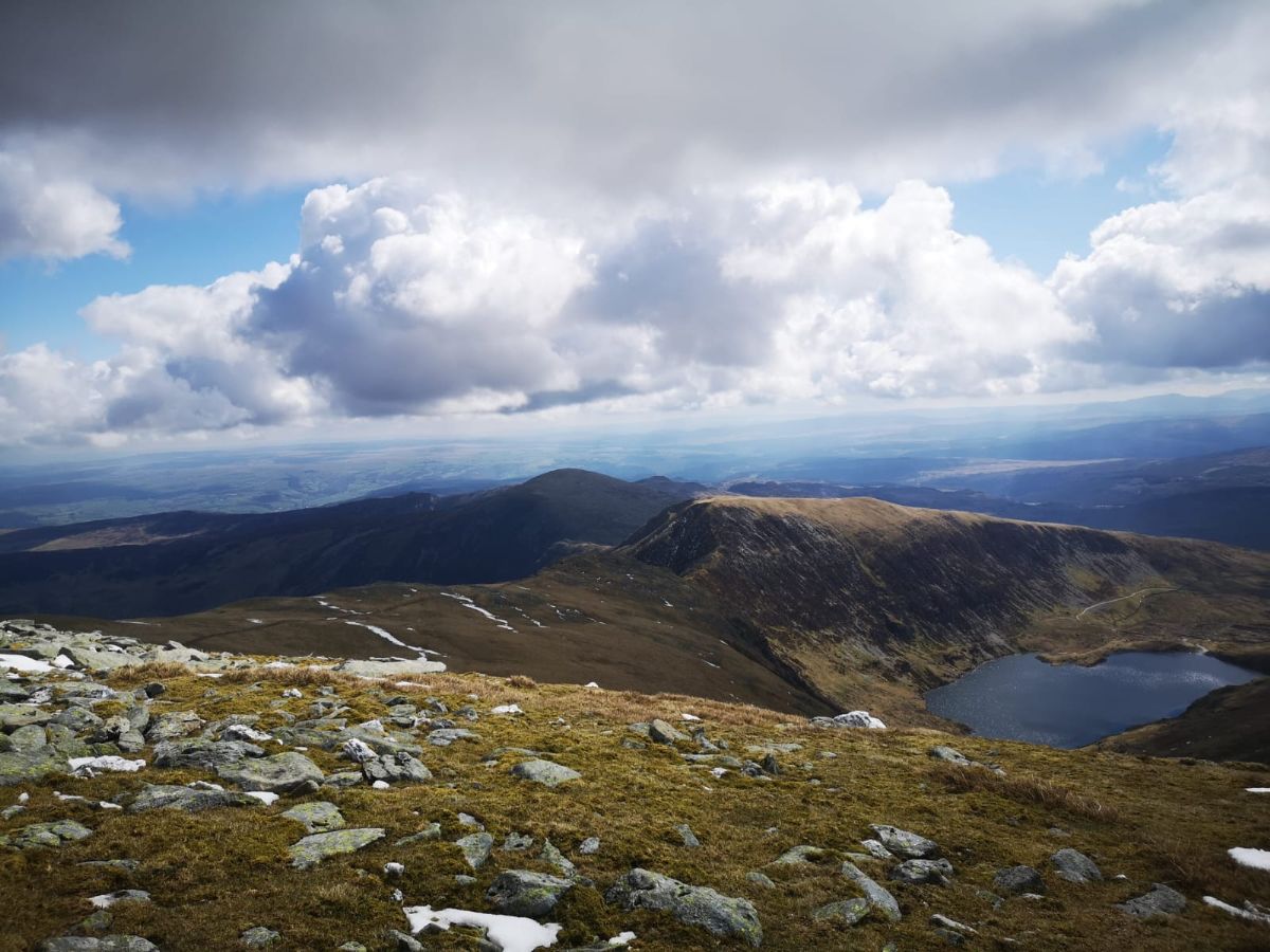 Summit view from Moel Sych, Wales, with mountain lake below